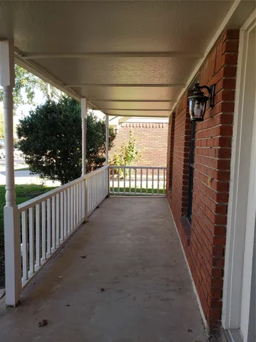 a view of a porch with wooden floor and outdoor space