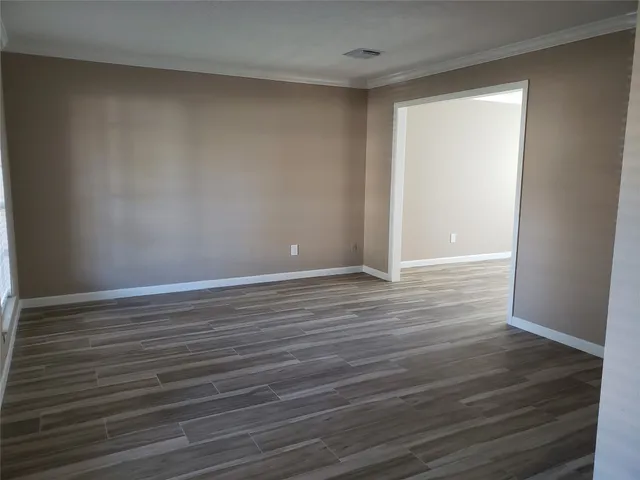 a view of room with wooden floor