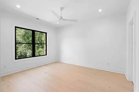 a view of a patio with chairs and floor to ceiling window