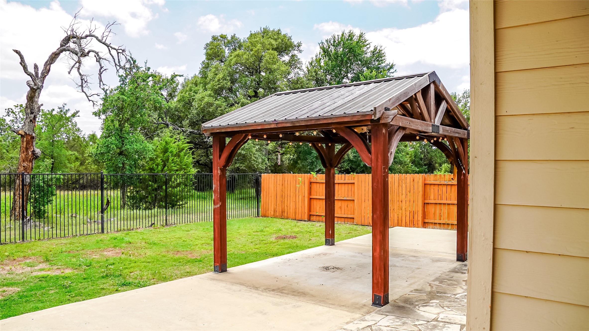184 Fort Cobb Way Georgetown, TX 78628 - Photo 32 of 33 a view of a backyard with a small cabin and wooden fence