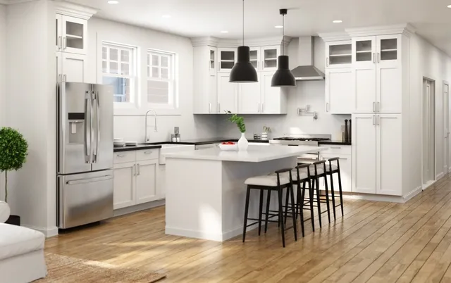 a kitchen with stainless steel appliances granite countertop a refrigerator a sink a stove and white cabinets with wooden floor