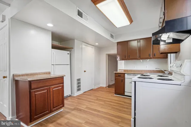 a kitchen with stainless steel appliances granite countertop a stove and a refrigerator