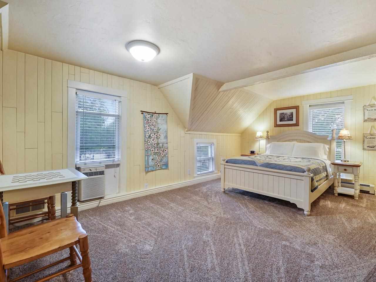 662 26 Road Grand Junction, CO 81506 - Photo 23 of 42 a spacious bedroom with a bed and a table in it