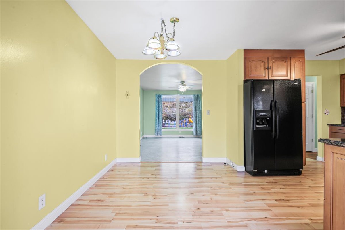 1513 Gates Drive Rantoul, IL 61866 - Photo 12 of 37 a view of a hallway with wooden floor and a chandelier