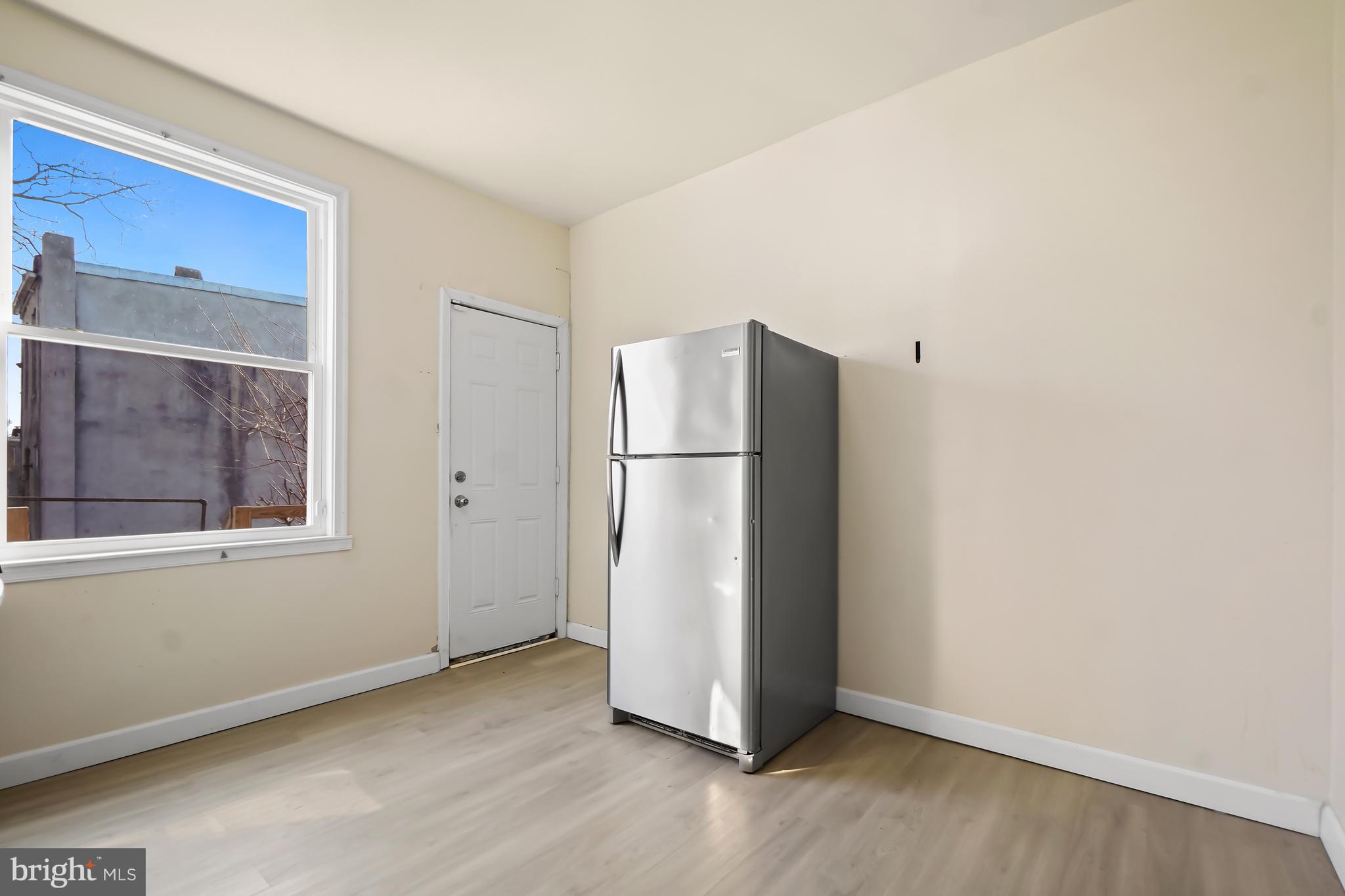 2427 East Lanvale Street Baltimore, MD 21213 - Photo 12 of 29 a view of a refrigerator in kitchen and an empty room