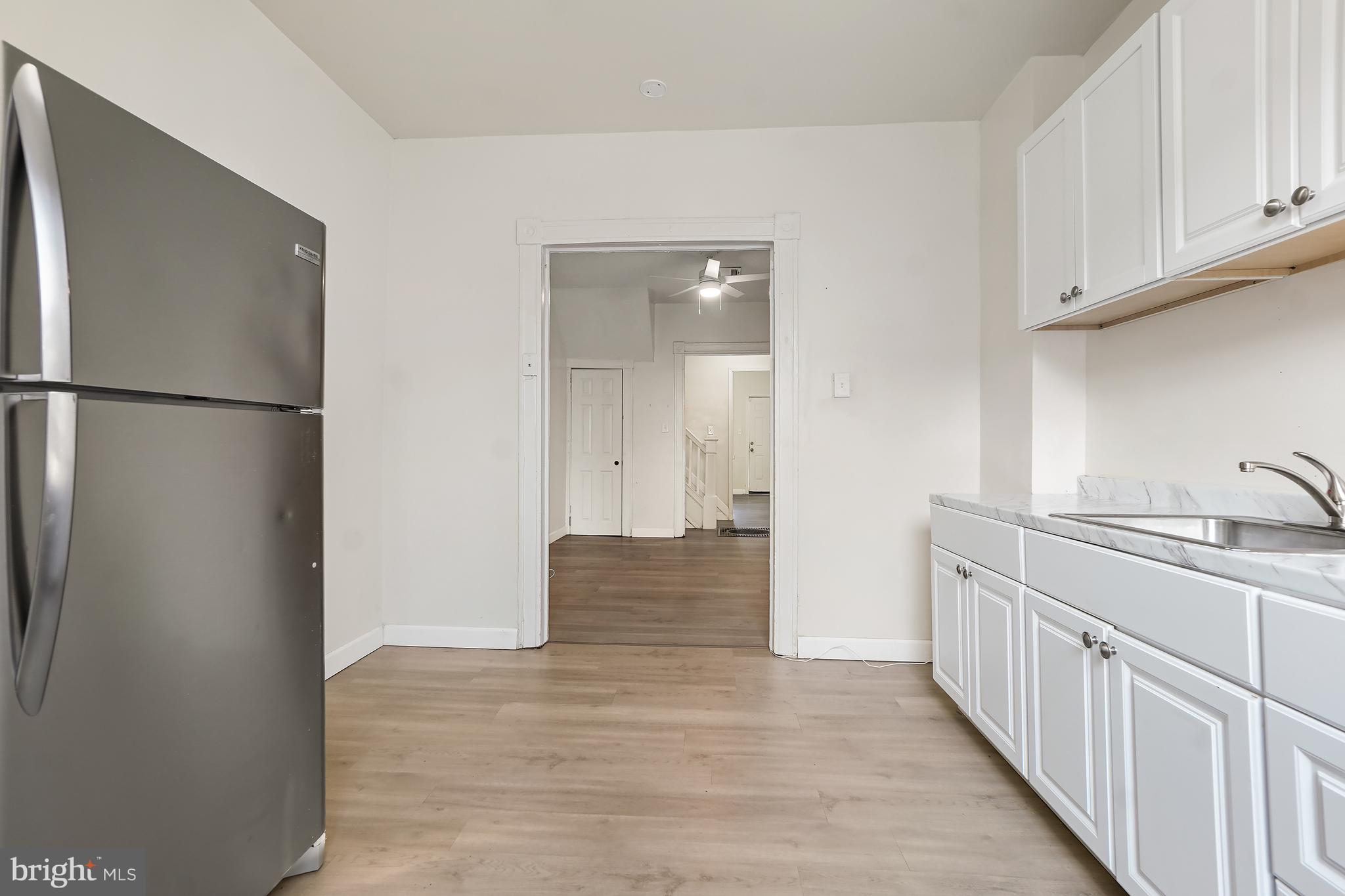 2427 East Lanvale Street Baltimore, MD 21213 - Photo 13 of 29 a view of a kitchen from the hallway