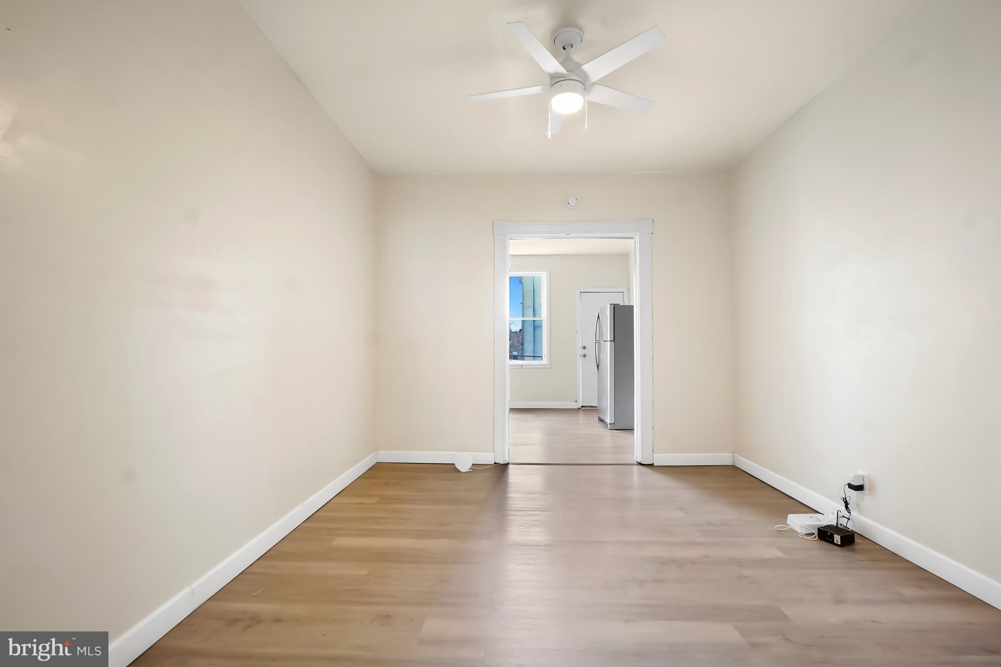 2427 East Lanvale Street Baltimore, MD 21213 - Photo 22 of 29 a view of a room with wooden floor and ceiling fan