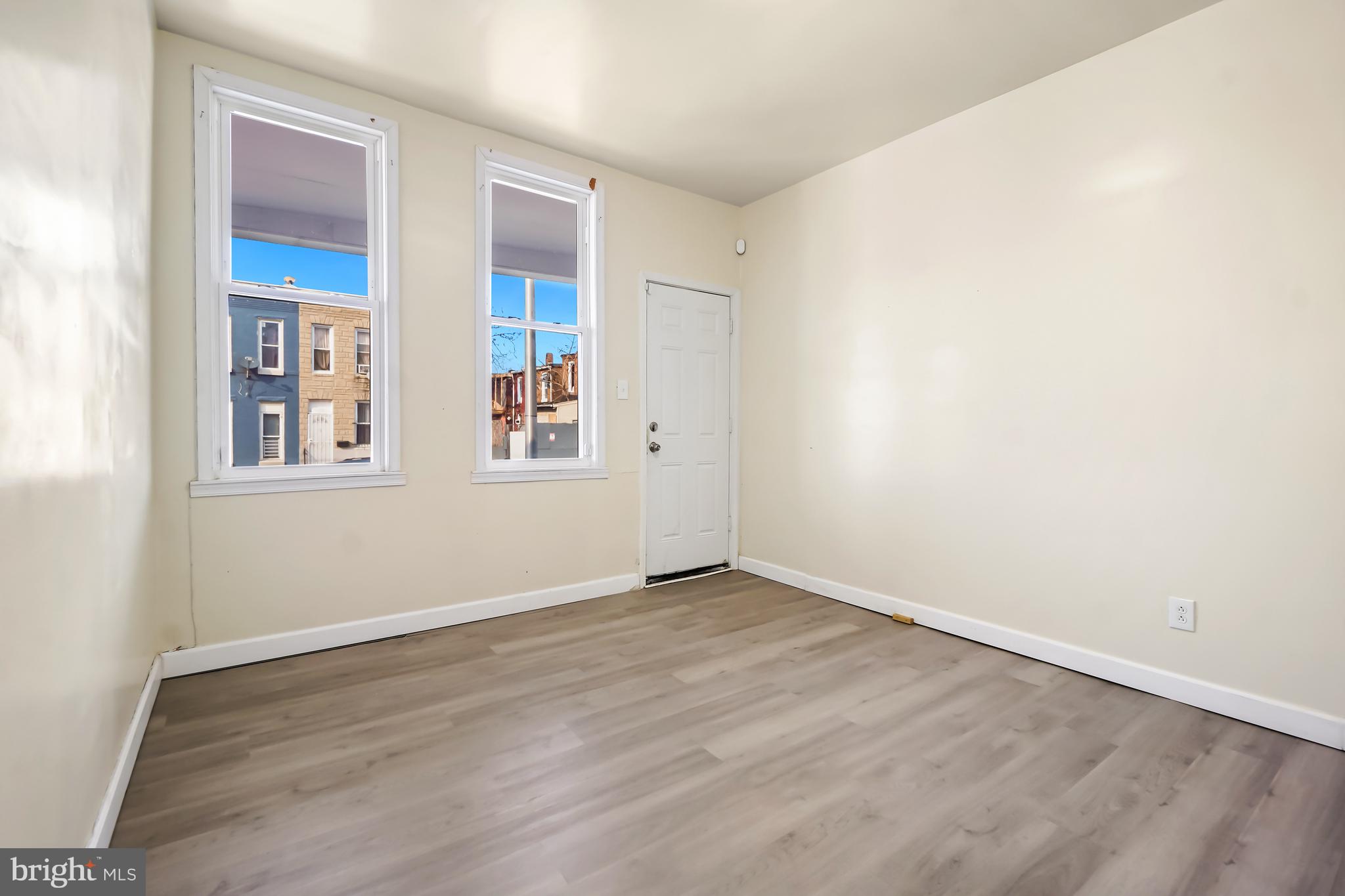 2427 East Lanvale Street Baltimore, MD 21213 - Photo 23 of 29 an empty room with wooden floor and windows