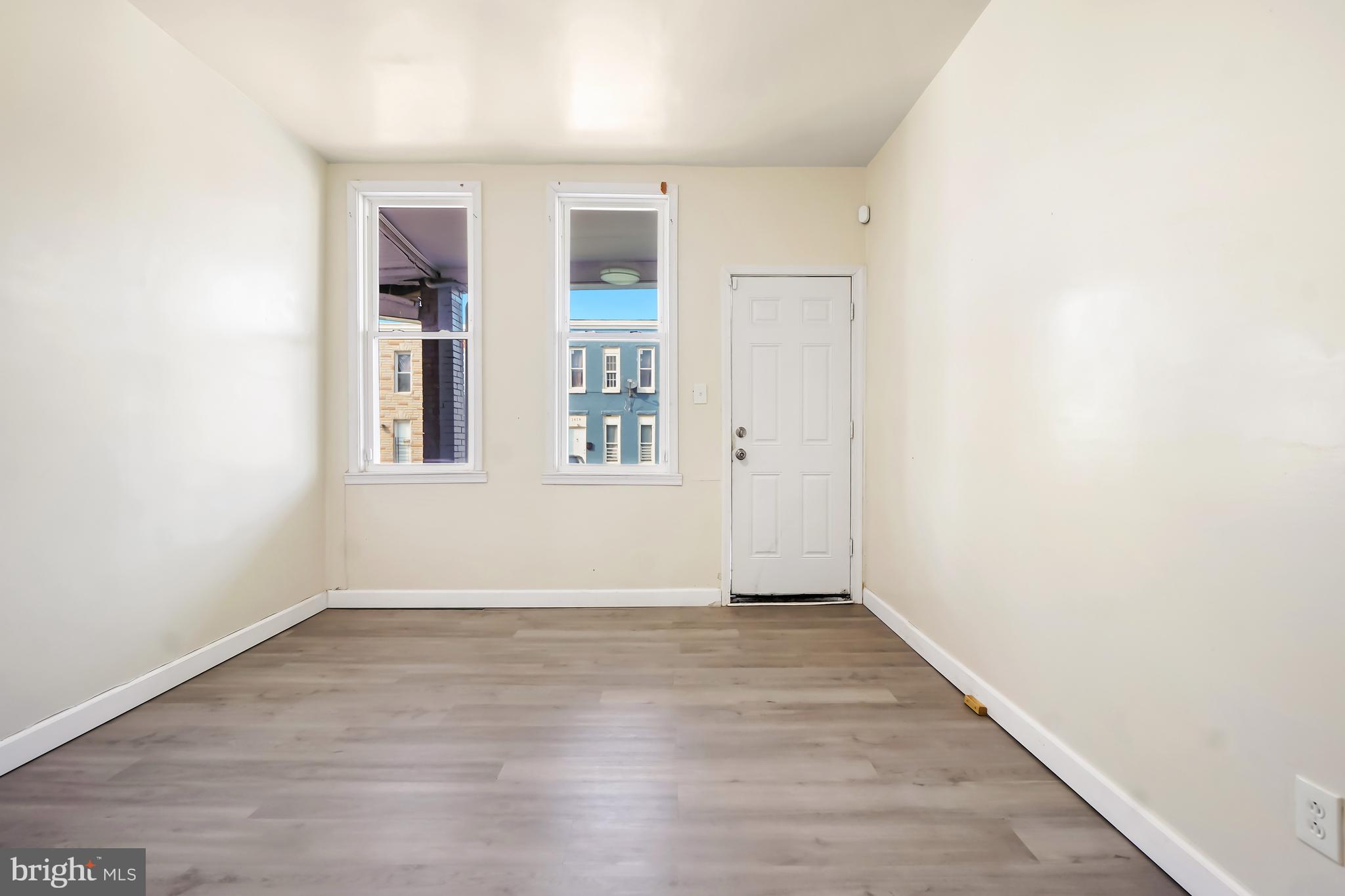 2427 East Lanvale Street Baltimore, MD 21213 - Photo 24 of 29 an empty room with wooden floor and windows