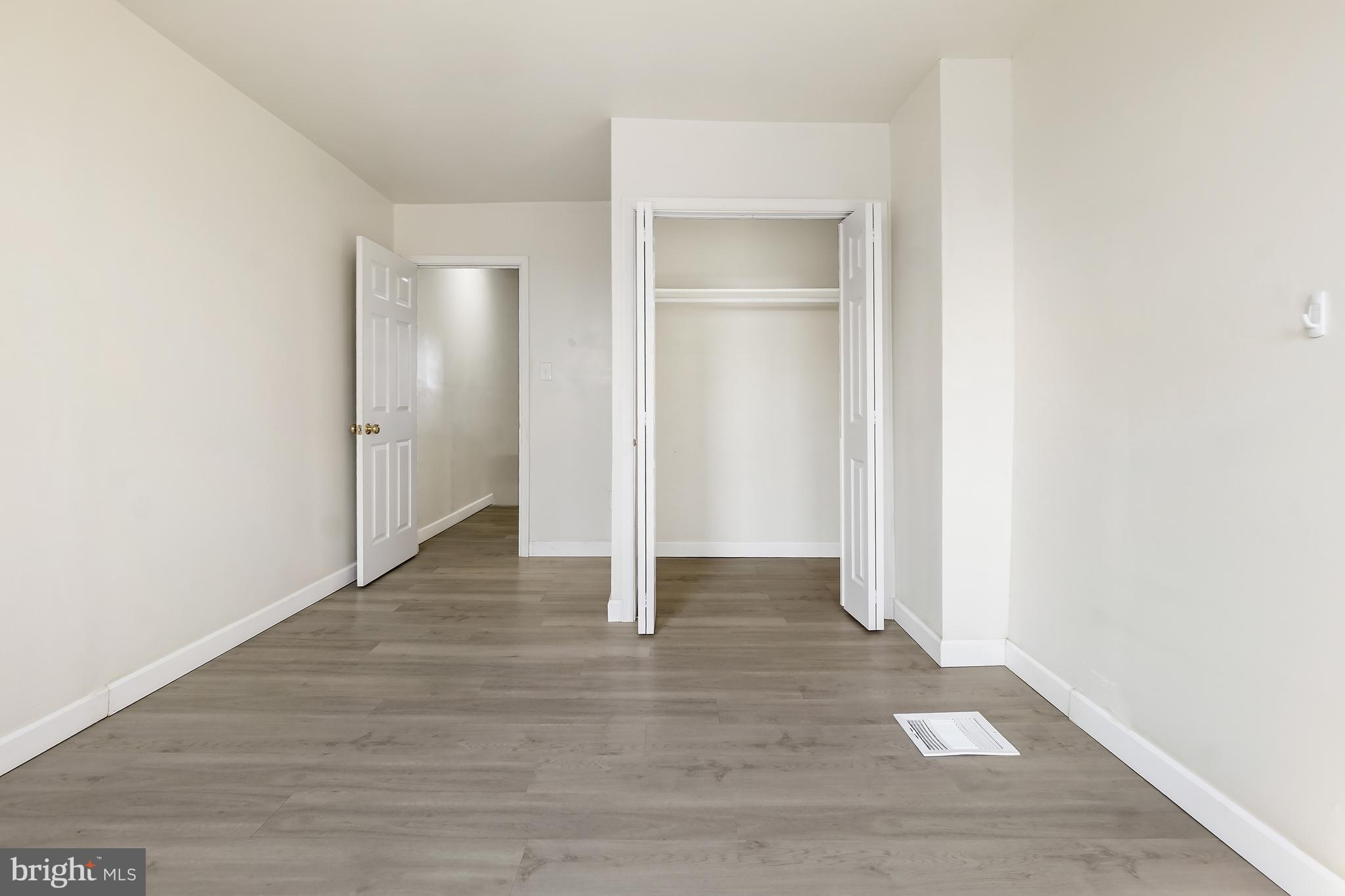 2427 East Lanvale Street Baltimore, MD 21213 - Photo 26 of 29 a view of an empty room with wooden floor and closet