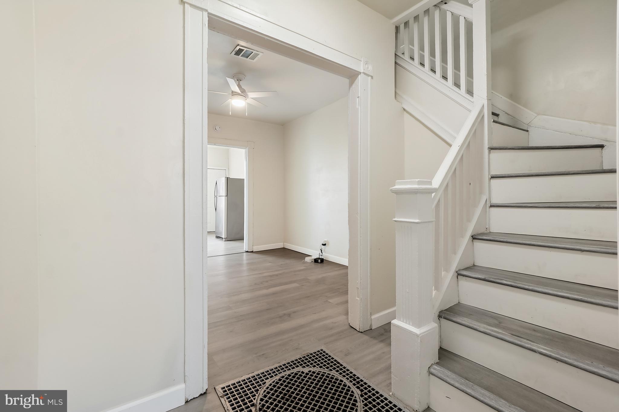 2427 East Lanvale Street Baltimore, MD 21213 - Photo 4 of 29 a view of staircase with white walls and a rug