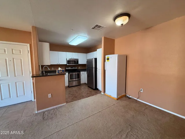 a open kitchen with cabinets and stainless steel appliances