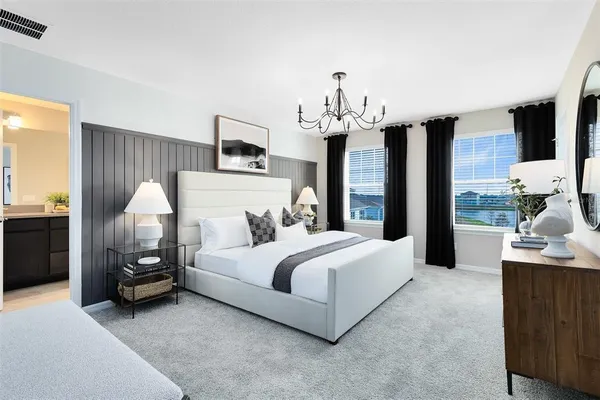 a bedroom with a bed and a chandelier