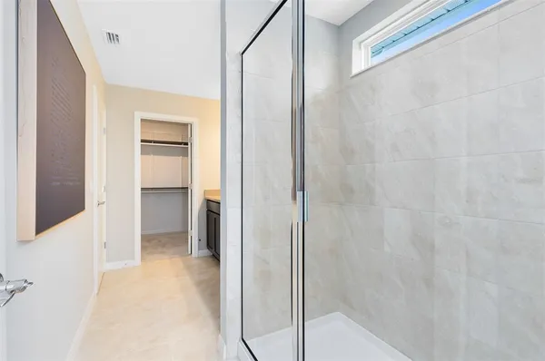a bathroom with a shower and a glass door
