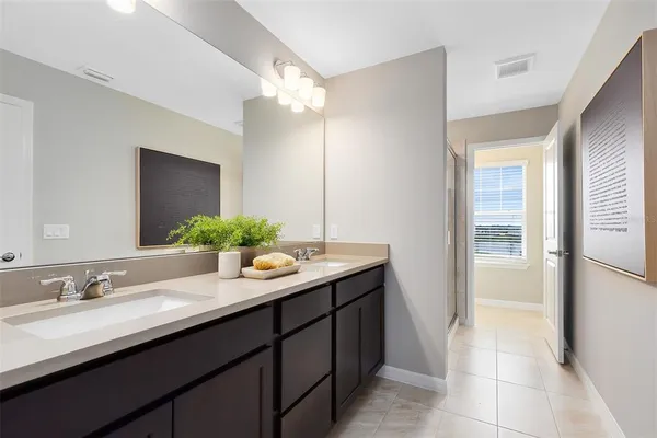 a bathroom with a sink double vanity granite and a mirror