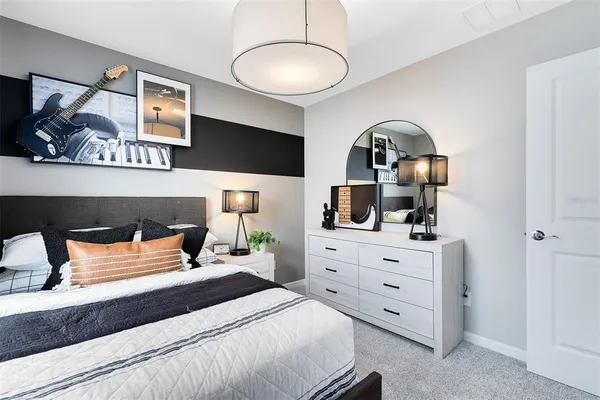 a bedroom with a bed and a dresser