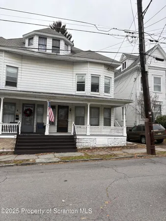 a view of a white building with large windows