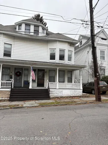 a view of a white building with large windows