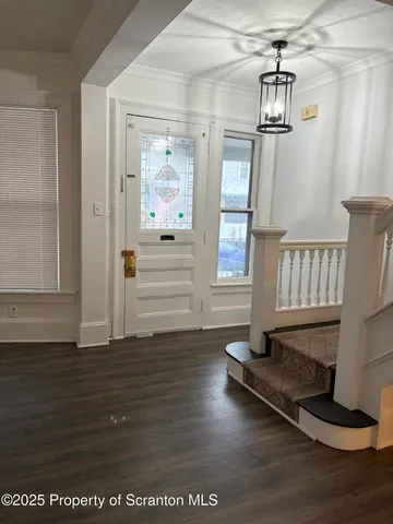 a view of empty room with wooden floor
