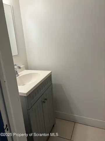 a white toilet sitting next to a shower