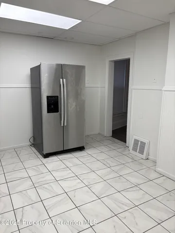 a view of a kitchen and an empty space and a window