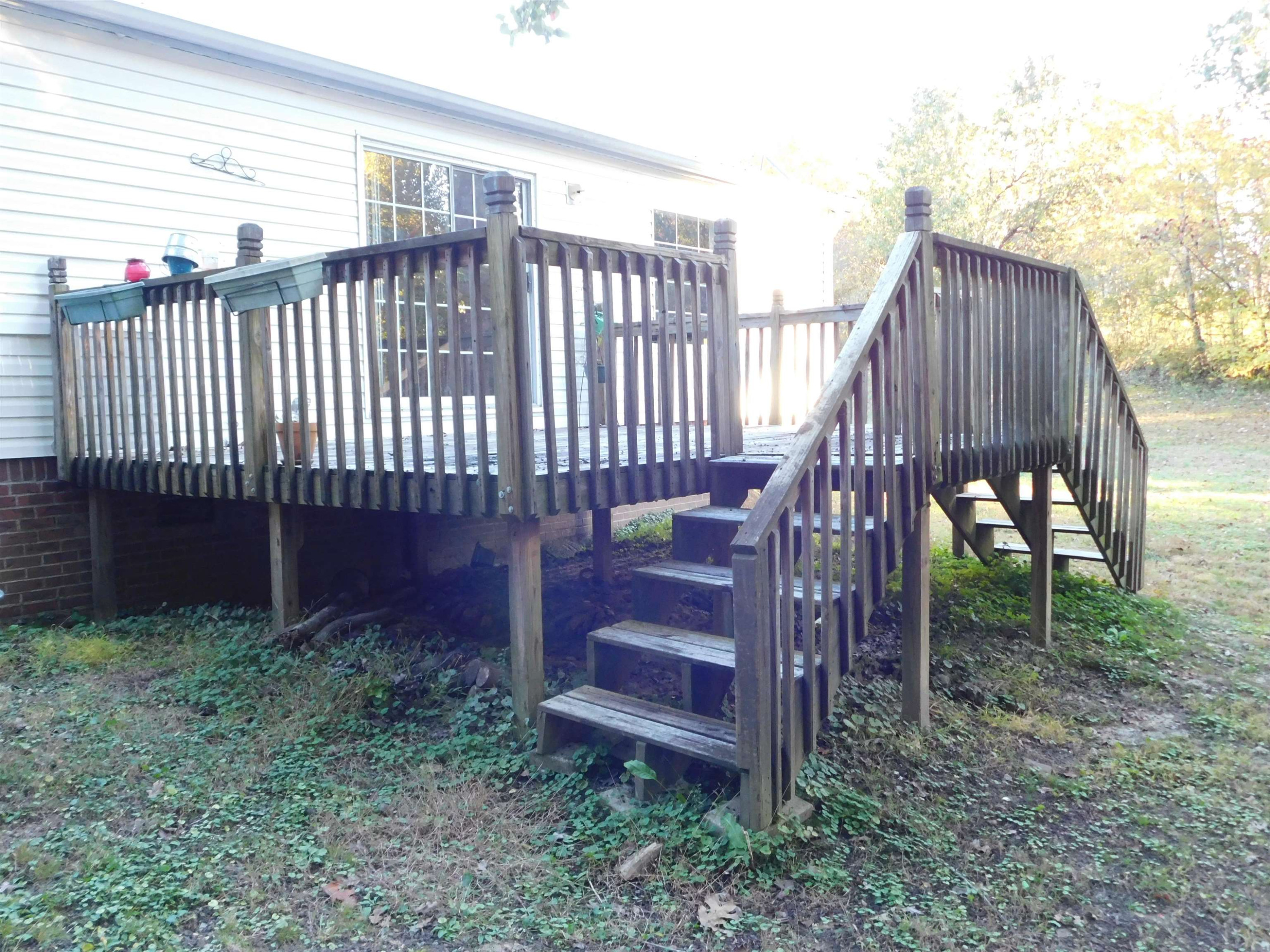 479 Fowler Road Beech Bluff, TN 38313 - Photo 17 of 18 a view of a backyard with plants and wooden fence