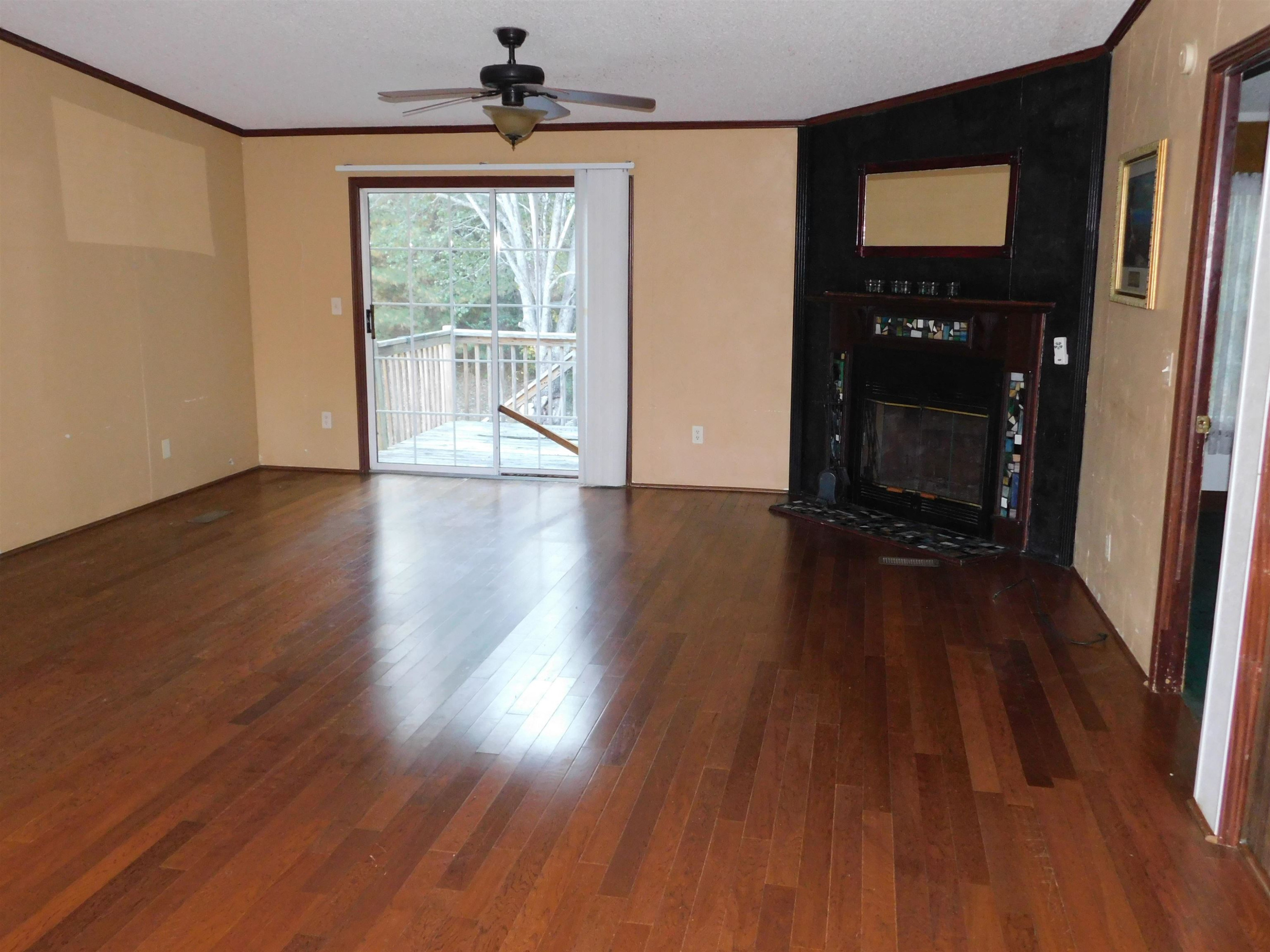 479 Fowler Road Beech Bluff, TN 38313 - Photo 3 of 18 an empty room with wooden floor and windows