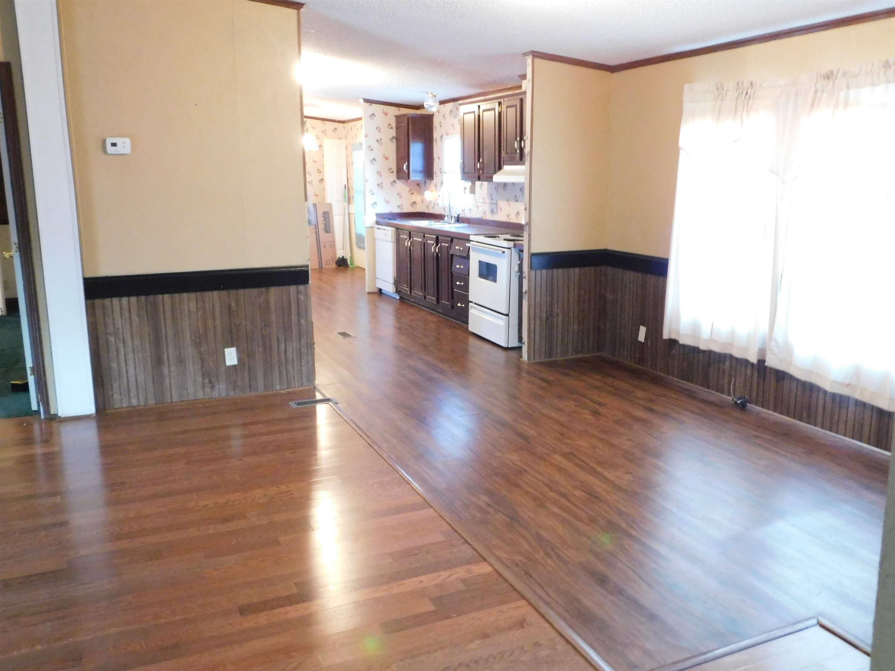 479 Fowler Road Beech Bluff, TN 38313 - Photo 4 of 18 a view of a kitchen with wooden floor and a window