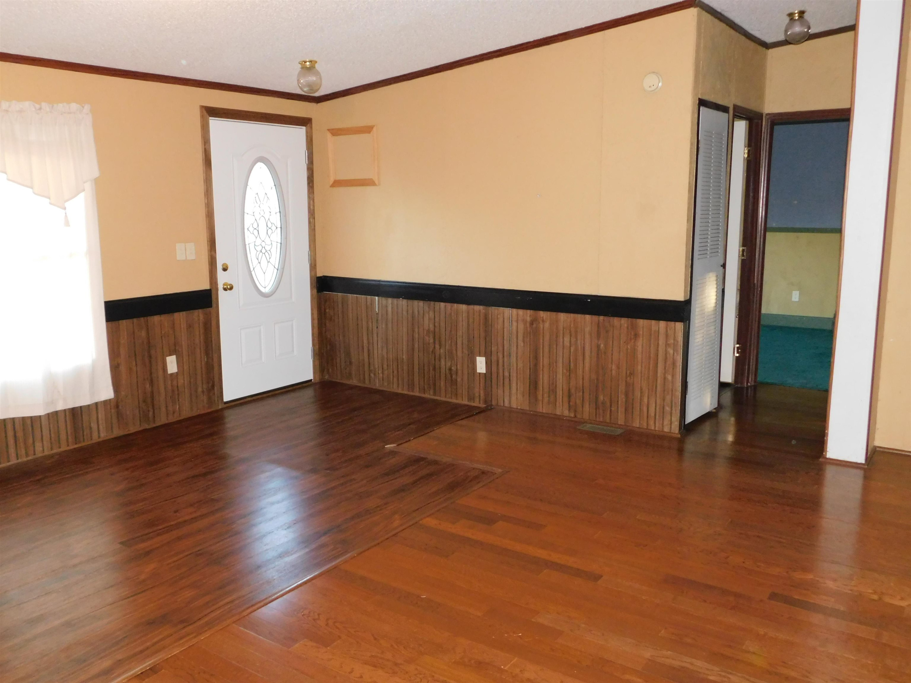 479 Fowler Road Beech Bluff, TN 38313 - Photo 5 of 18 a view of an empty room with wooden floor and a window