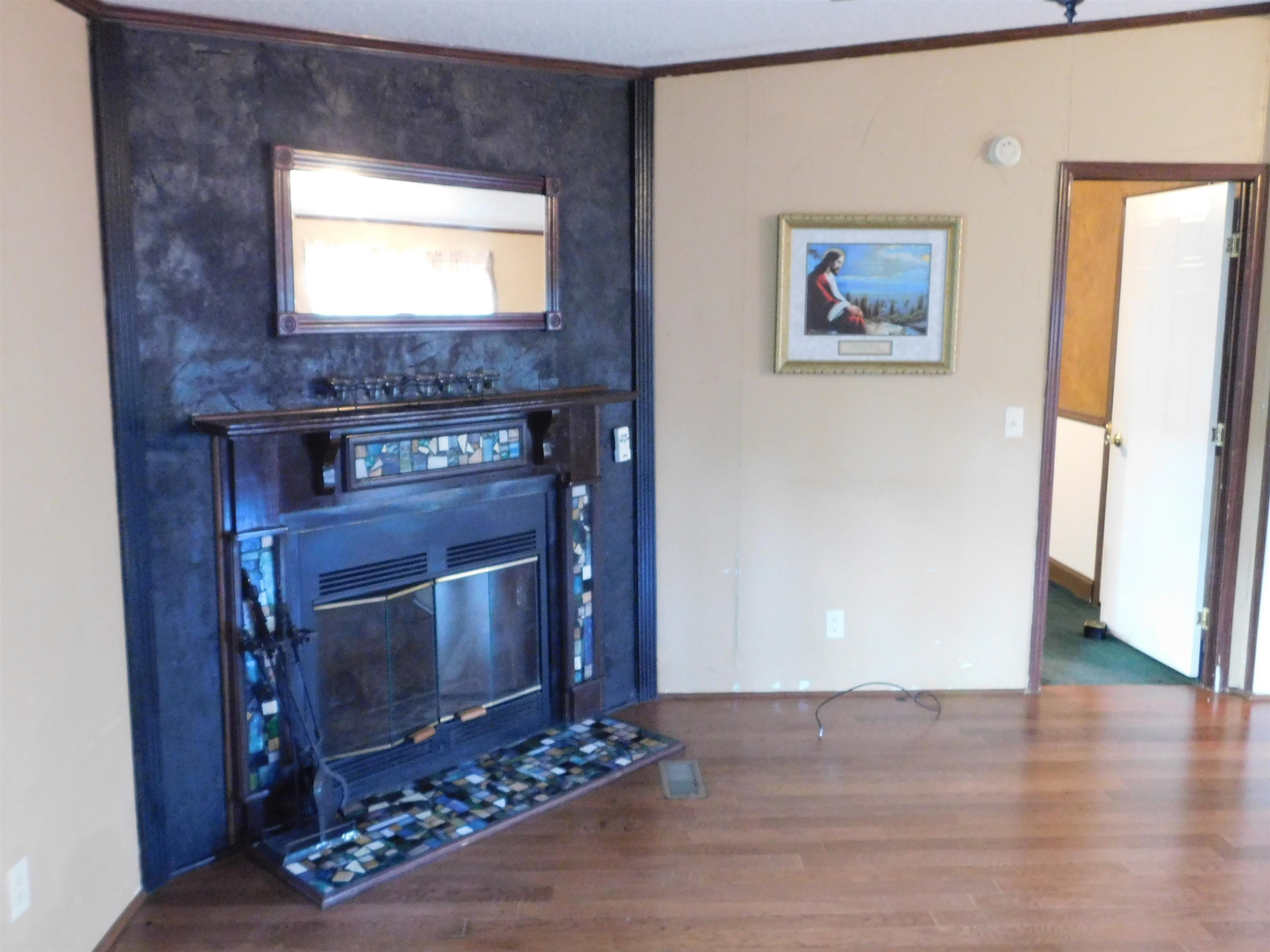 479 Fowler Road Beech Bluff, TN 38313 - Photo 7 of 18 a living room with stainless steel appliances wooden floor and a flat screen tv
