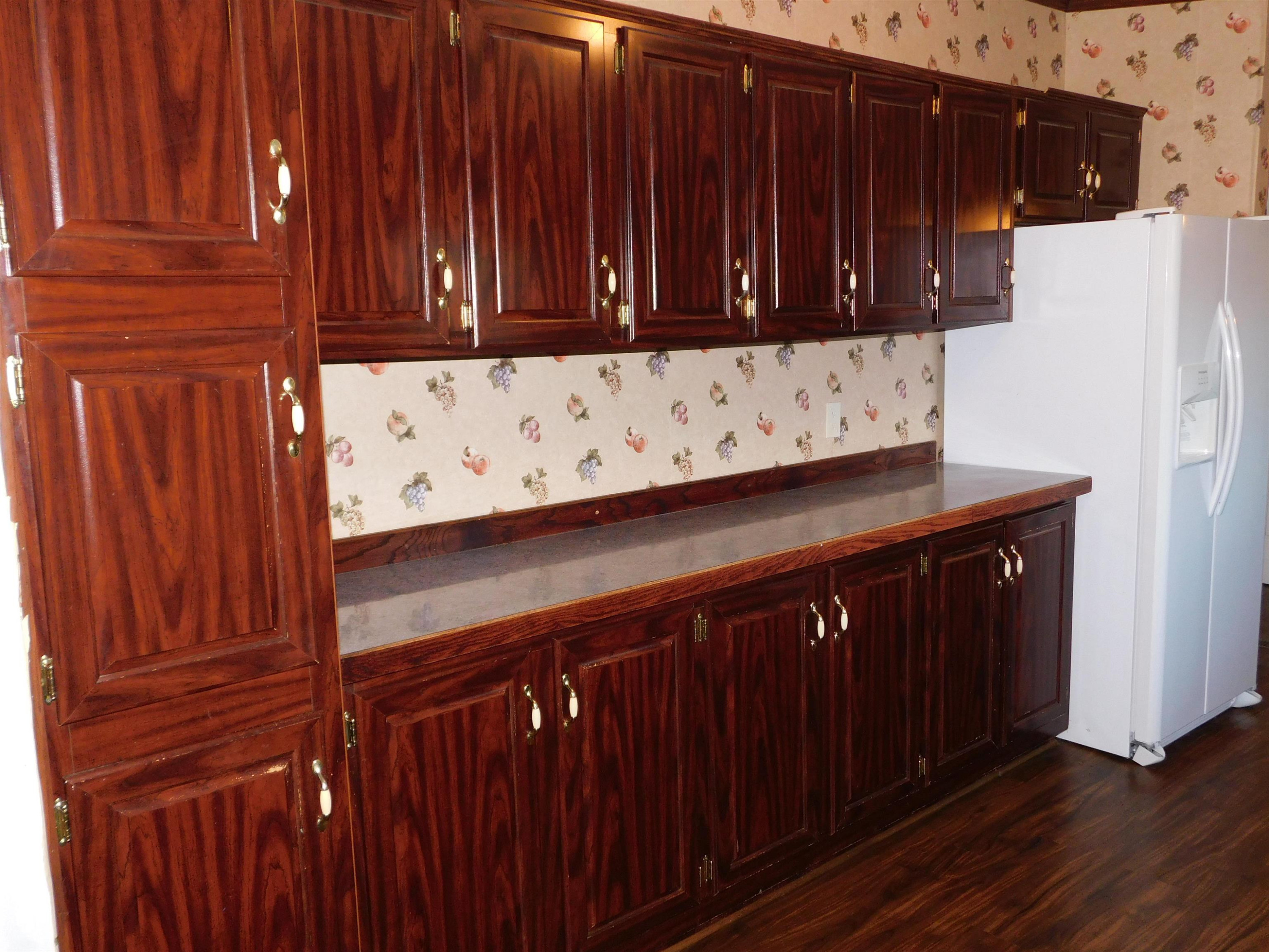479 Fowler Road Beech Bluff, TN 38313 - Photo 10 of 18 a kitchen with wooden cabinets and a sink
