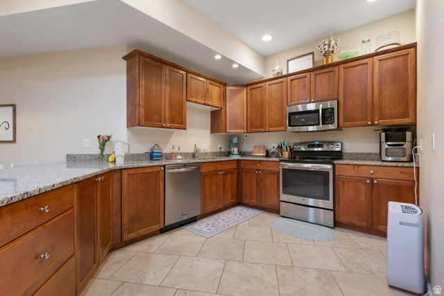 684 North Summit Way Alpine, UT 84004 - Photo 53 of 58 Kitchen featuring stainless steel appliances, wood finish cabinets, light stone counters, and recessed lighting