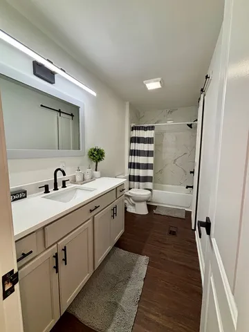 a spacious bathroom with a double vanity sink a mirror and a shower