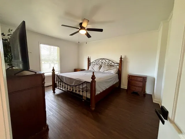 a bedroom with a bed and a chandelier