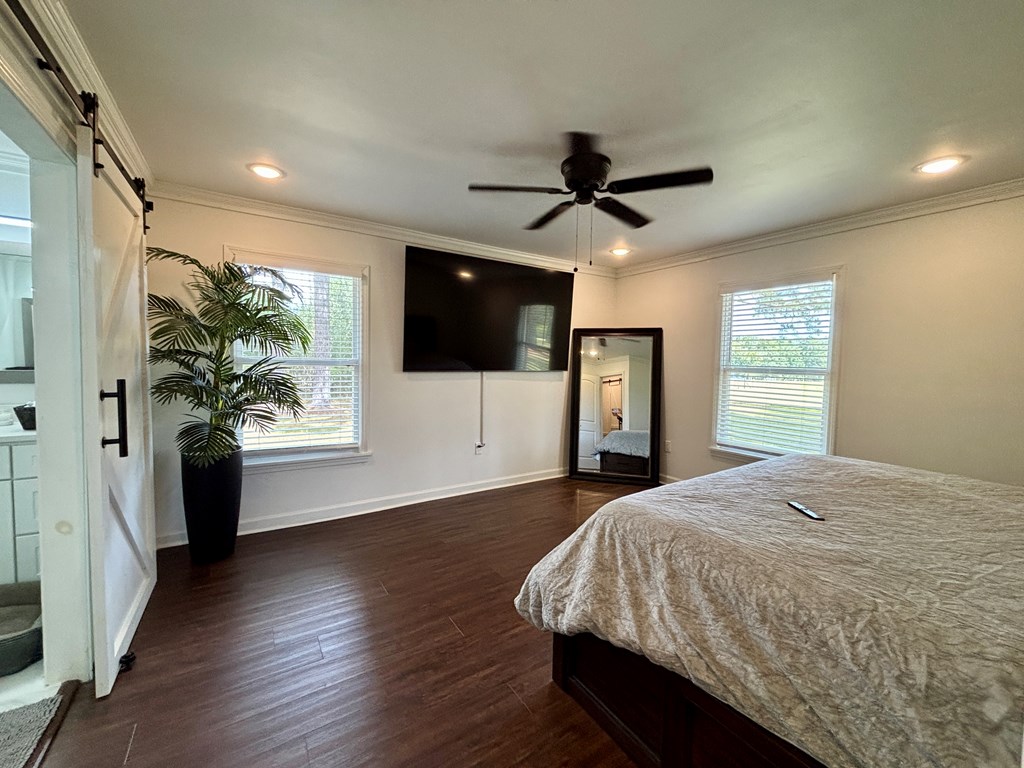 142 Gammage Road Eufaula, AL 36027 - Photo 23 of 47 a spacious bedroom with a large bed a flat tv screen and dresser