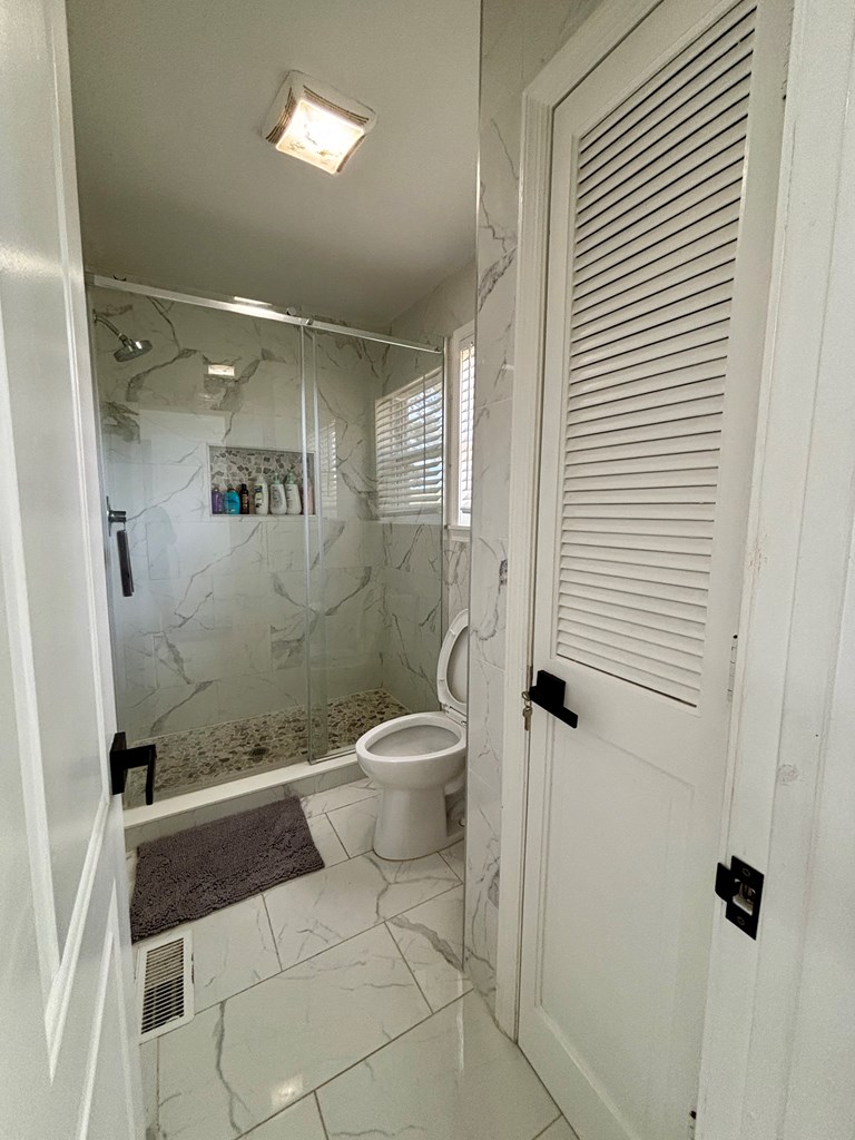 142 Gammage Road Eufaula, AL 36027 - Photo 25 of 47 a bathroom with a toilet and a shower