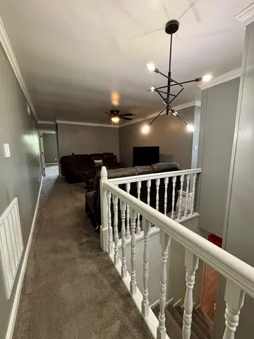 a view of a hallway with stairs