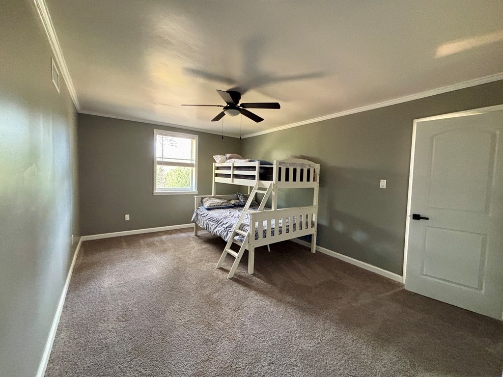 142 Gammage Road Eufaula, AL 36027 - Photo 30 of 47 a bedroom with a bed and a ceiling fan