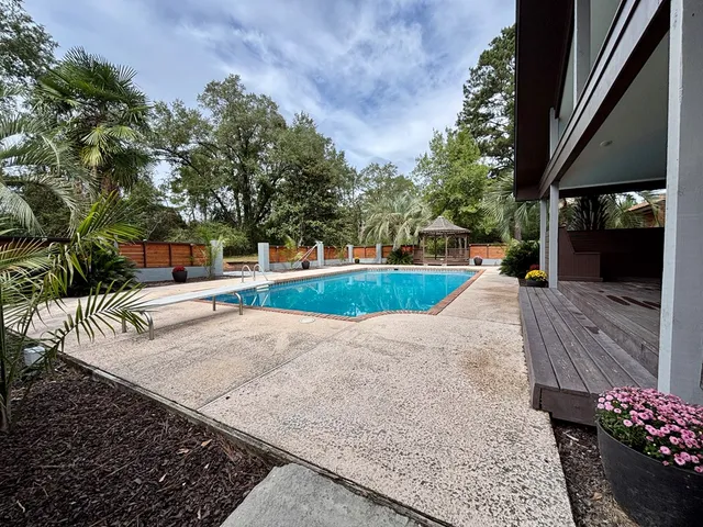 swimming pool view with a sitting space