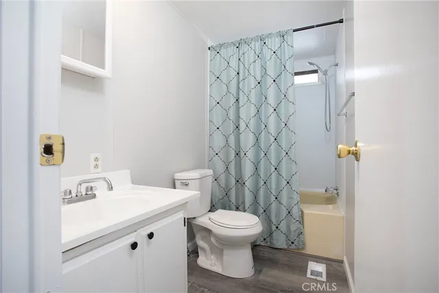 a bathroom with a shower curtain and a toilet