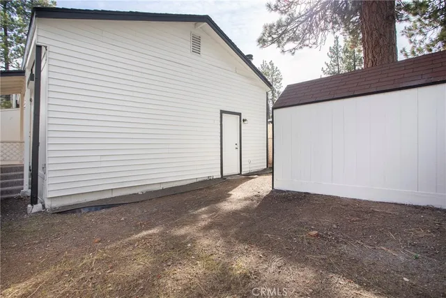 a view of a house with a white wall and a large window