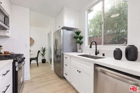 a kitchen with a refrigerator and a sink