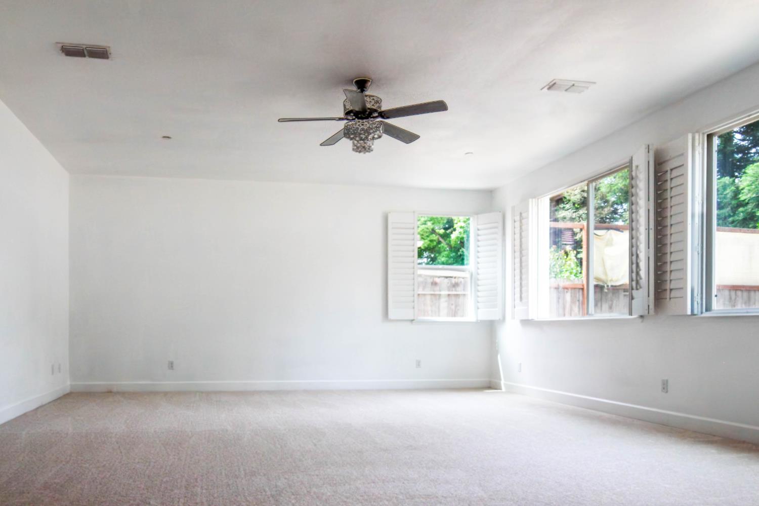 1817 Thomas Court Modesto, CA 95355 - Photo 4 of 20 wooden floor in an empty room with a window