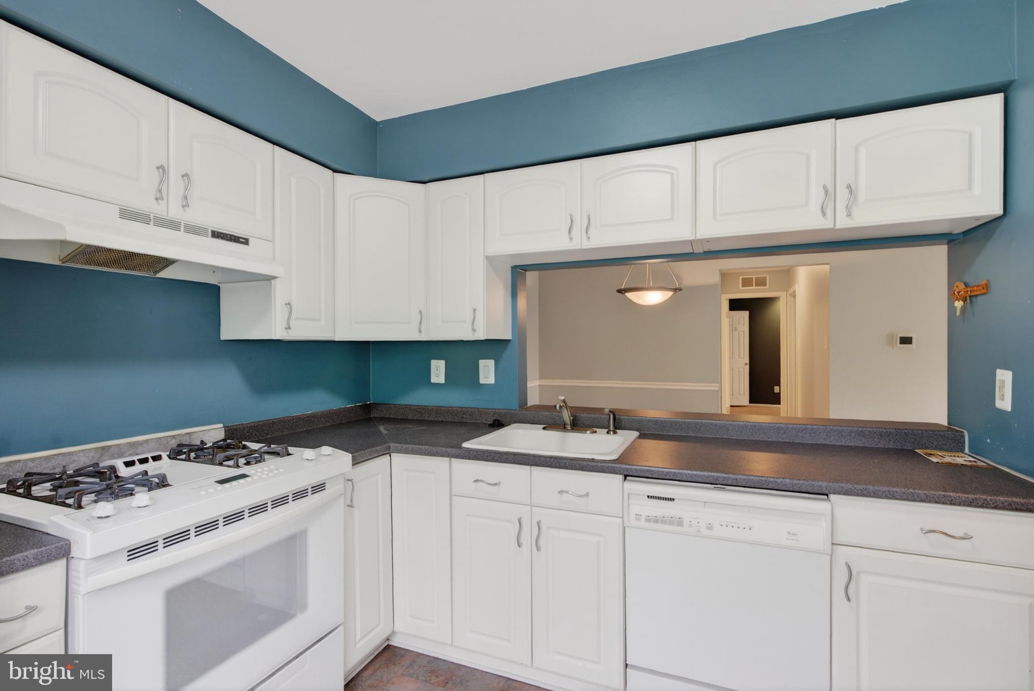 3302 B Ramsbury Court Mount Laurel, NJ 08054 - Photo 5 of 16 a kitchen with granite countertop white cabinets and white appliances