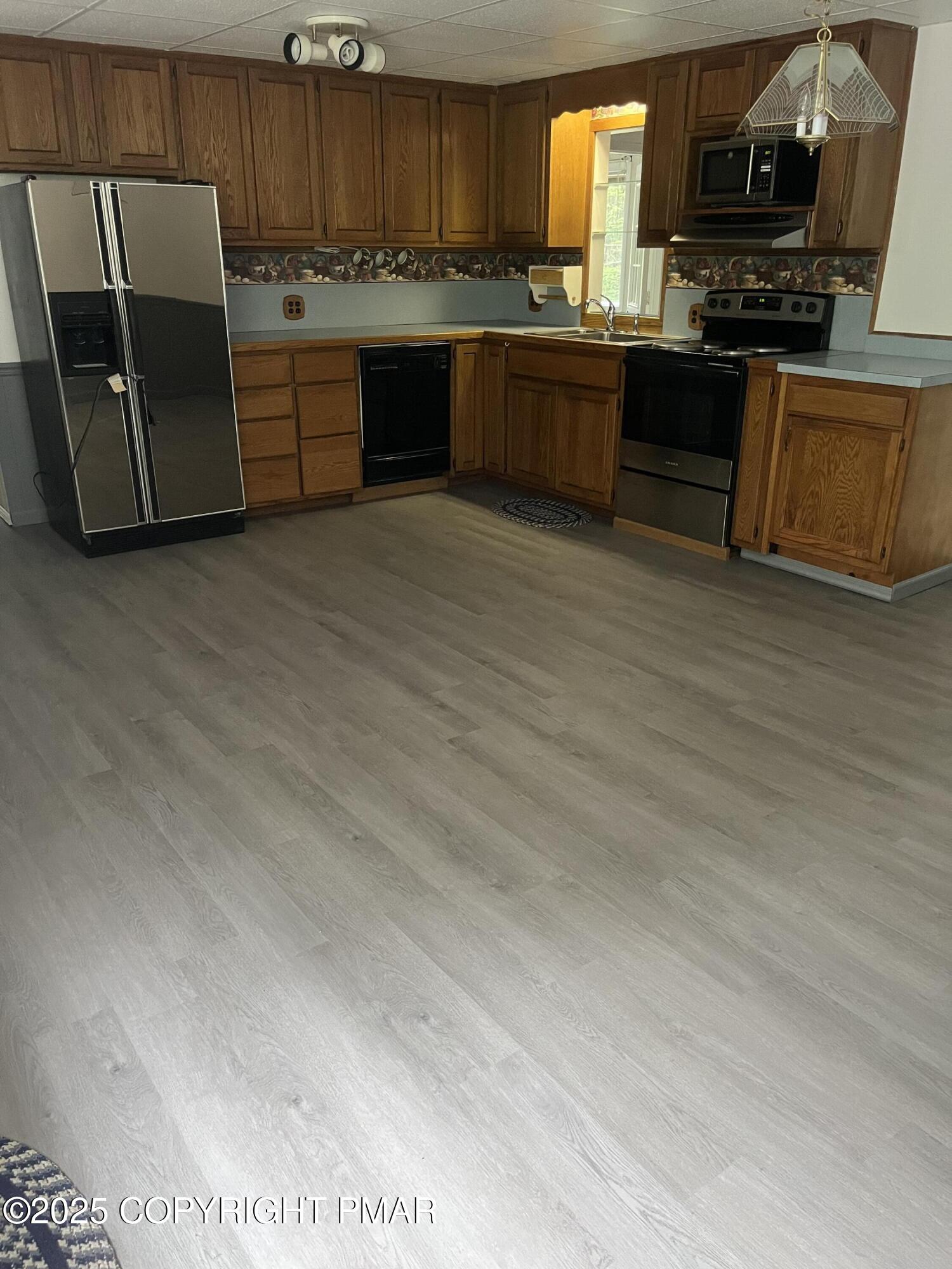 529 Pine Ridge Road Stroudsburg, PA 18360 - Photo 11 of 36 a kitchen with stainless steel appliances granite countertop a stove top oven a sink dishwasher and a microwave oven on granite countertops