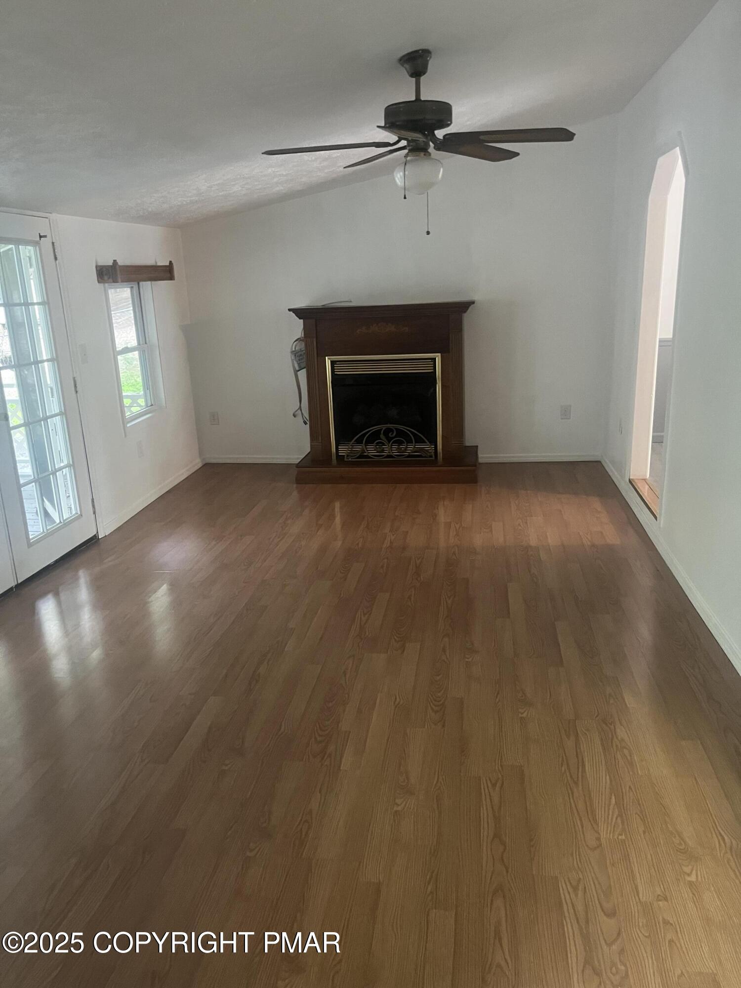 529 Pine Ridge Road Stroudsburg, PA 18360 - Photo 17 of 36 an empty room with windows and fireplace