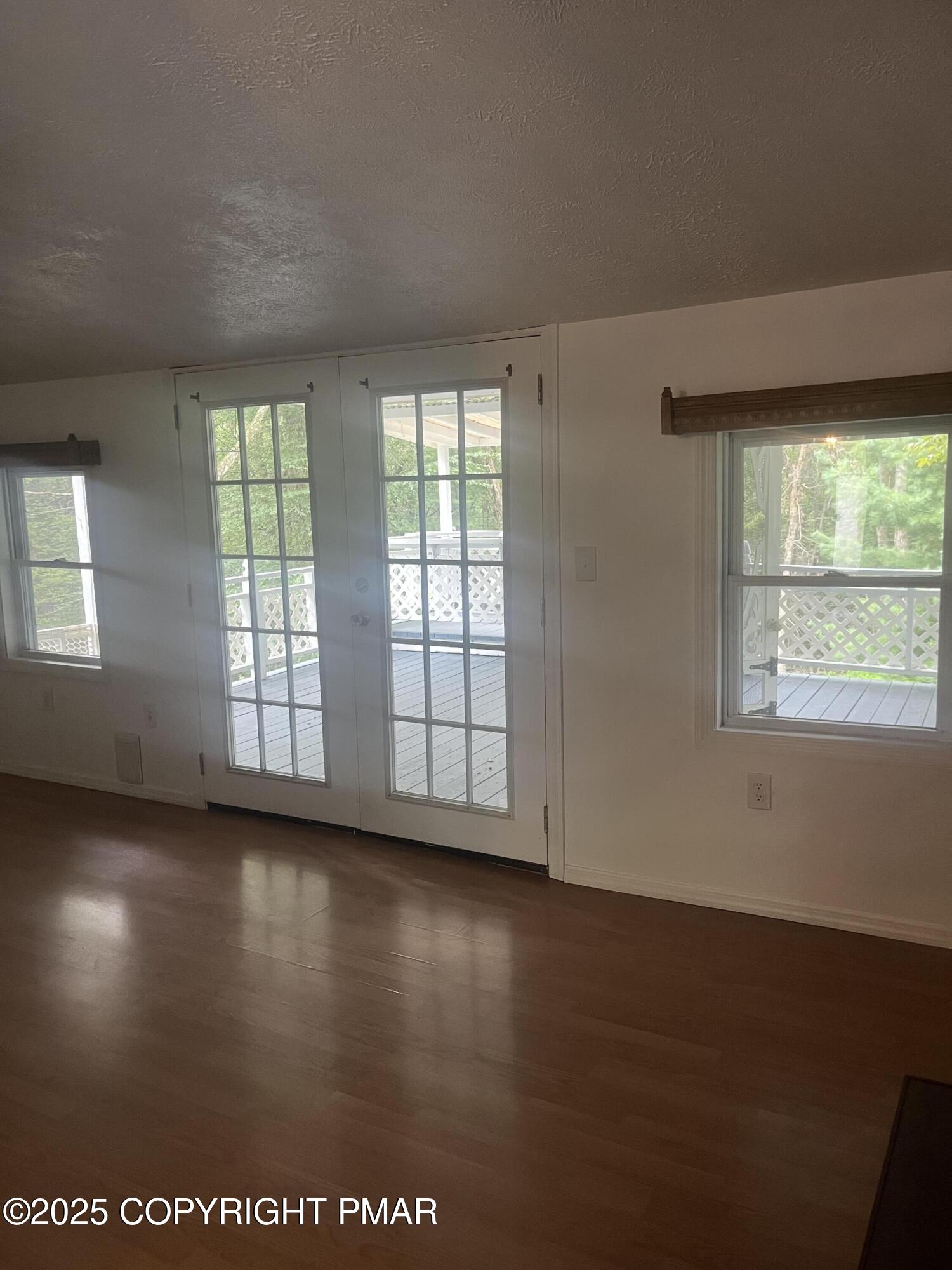 529 Pine Ridge Road Stroudsburg, PA 18360 - Photo 18 of 36 an empty room with wooden floor and windows