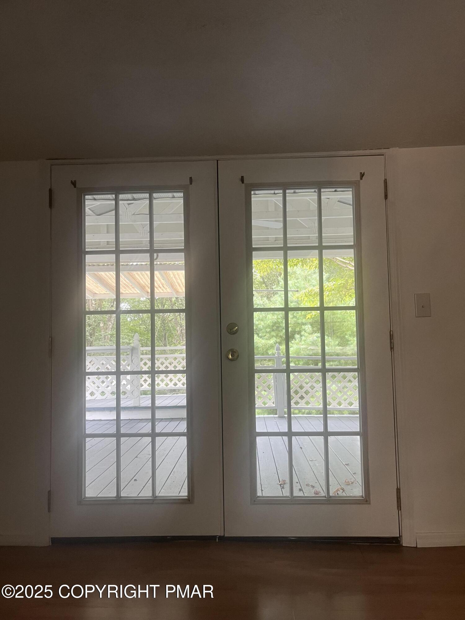 529 Pine Ridge Road Stroudsburg, PA 18360 - Photo 19 of 36 an empty room with wooden floor and windows