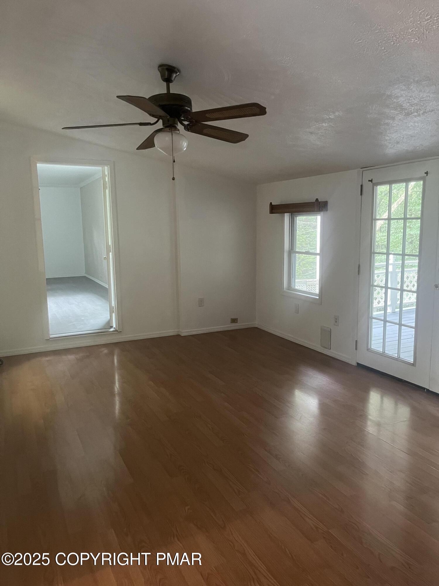 529 Pine Ridge Road Stroudsburg, PA 18360 - Photo 20 of 36 an empty room with wooden floor cabinet and windows