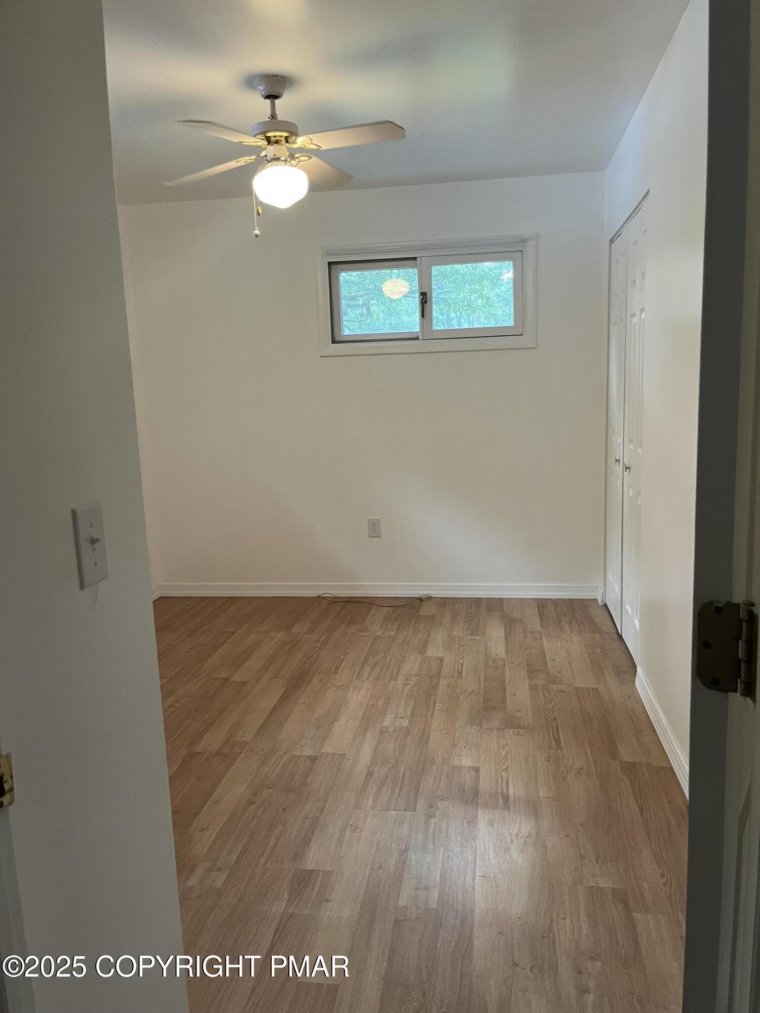 529 Pine Ridge Road Stroudsburg, PA 18360 - Photo 30 of 36 an empty room with a window and a ceiling fan